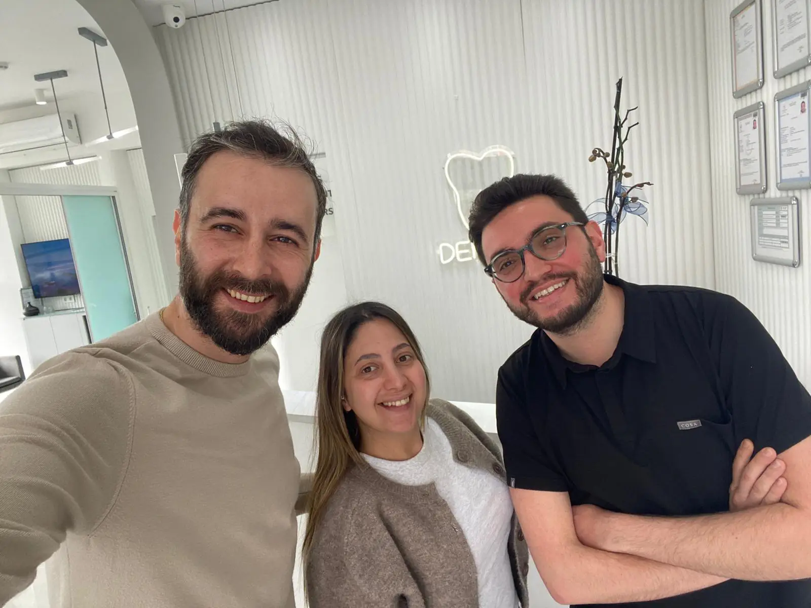 Smiling dental team at EsteQuality Clinic in Umraniye, Istanbul, in a modern clinic setting.