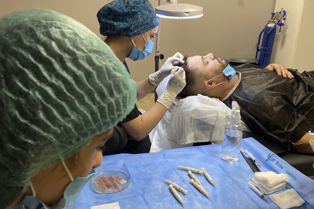 Team performing DHI implantation with loaded pens on a tray